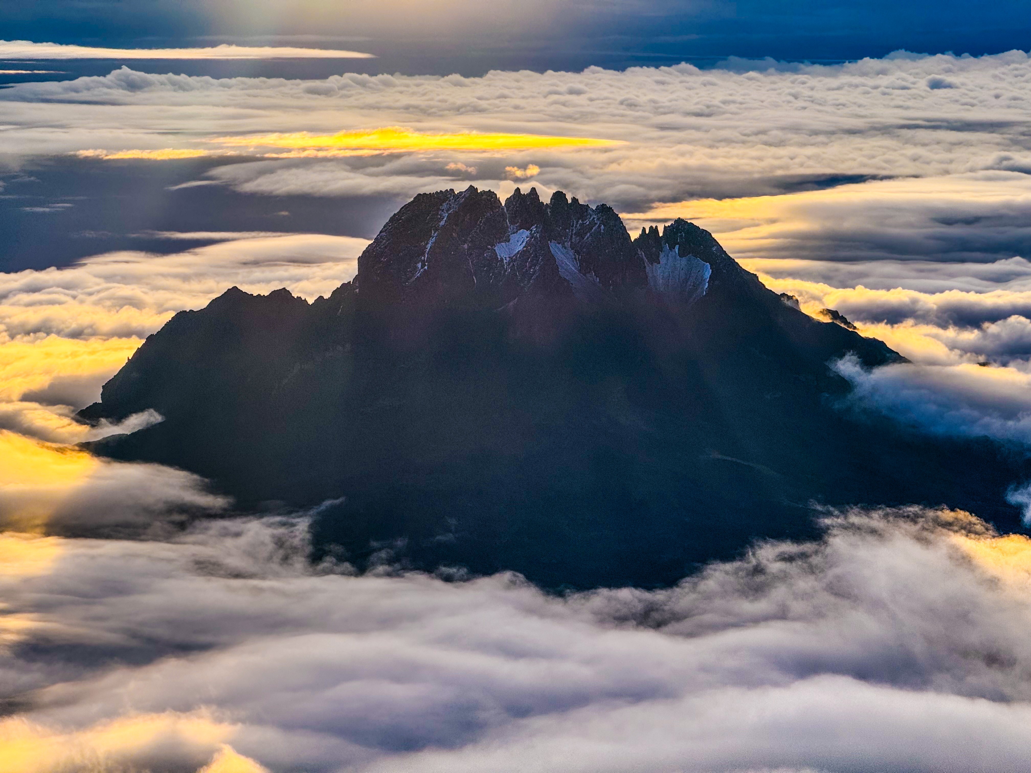 Peak rising above the clouds at sunset